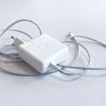 white apple charging adapter on white table