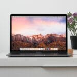 MacBook on top white table